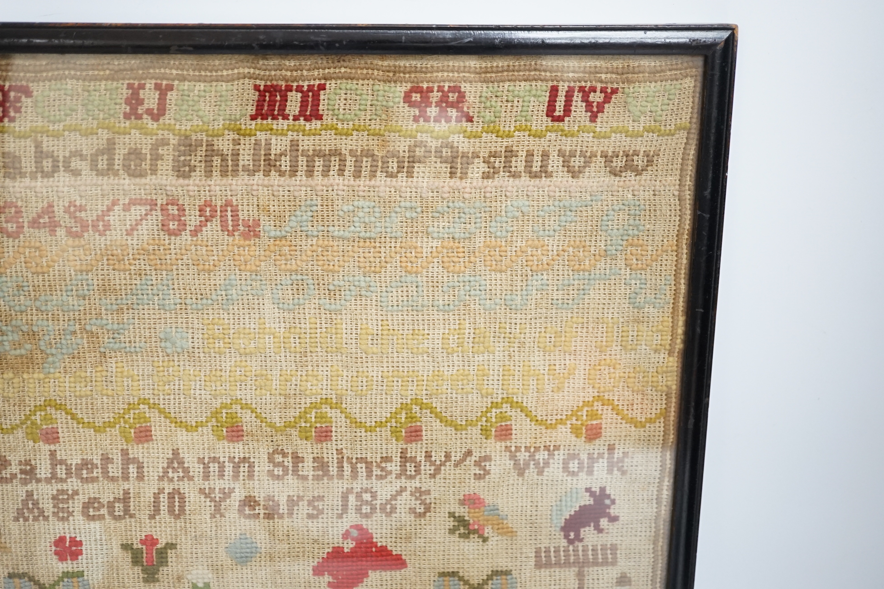 A fine cross stitch needlework sampler, by Sarah Graham, dated Oct 1842, in original frame, 36 x 30cms, and a later wool worked sampler ‘’Elizabeth Ann Stamsby’s Work Aged 10 Years 1865’’ (2)